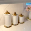 Inspire Me! Home Decor White Ceramic Jars With Gold Flower Lid (3 Sizes) 2 Inspire Me! Home Decor White Ceramic Jars With Gold Flower Lid (3 Sizes)